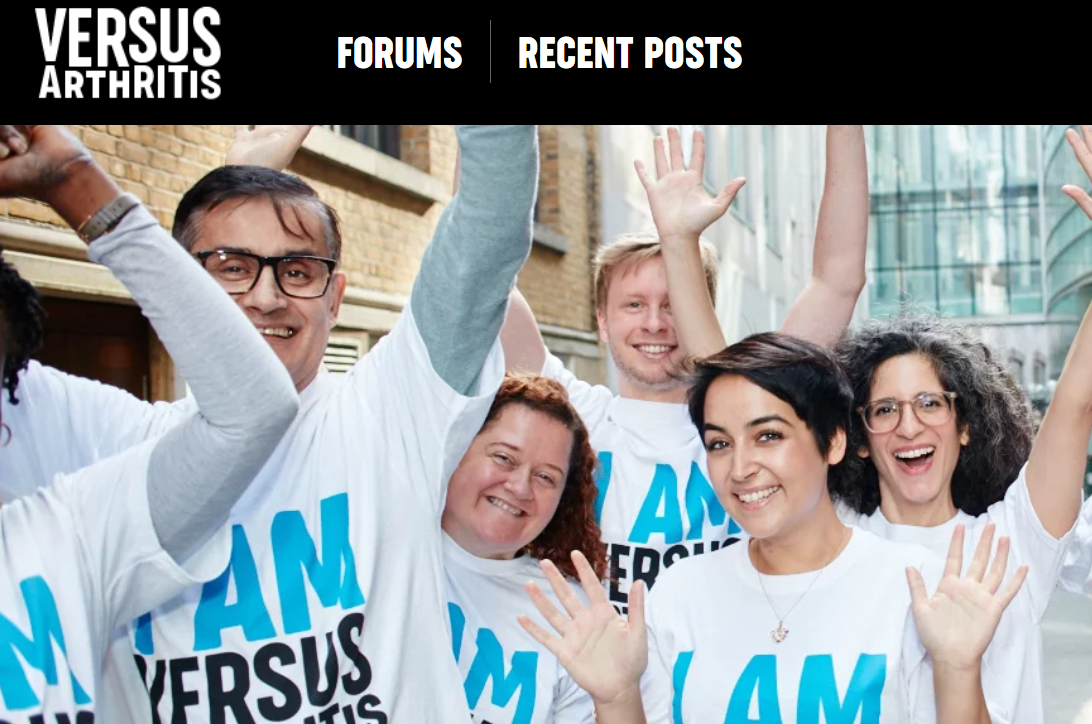 people wearing Versus Arthritis t-shirts with their hands in the